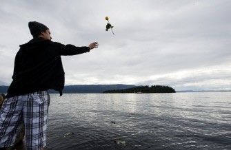 A man throws a rose on July 26, 2011 in the lake Tyrifjorden in Sundvolden facing the Utoeya island in honor of the victims of the July 22 shooting spree at a Labour Party youth summer camp on the island of Utoeya. A man throws a rose on July 26, 2011 in the lake Tyrifjorden in Sundvolden facing the Utoeya island in honor of the victims of the July 22 shooting spree at a Labour Party youth summer camp on the island of Utoeya.