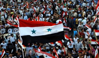 Thousands of Syrian citizens wave their national flags during a pro-government demonsration in Damascus, on July 26, 2011. Thousands of Syrian citizens wave their national flags during a pro-government demonsration in Damascus, on July 26, 2011.