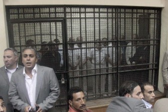 Egyptian former interior minister Habib al-Adly (L) stands with his deputies in a cage on the first day of their trial at Cairo's criminal court on July 25, 2011 Egyptian former interior minister Habib al-Adly (L) stands with his deputies in a cage on the first day of their trial at Cairo's criminal court on July 25, 2011