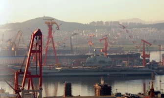 AFP file - This photo taken on July 4, 2011 shows China's first aircraft carrier, the former Soviet carrier Varyag which China bought from Ukraine in 1998, undergoing a re-fitting at the port of Dalian, in northeast China's Liaoning province. AFP file - This photo taken on July 4, 2011 shows China's first aircraft carrier, the former Soviet carrier Varyag which China bought from Ukraine in 1998, undergoing a re-fitting at the port of Dalian, in northeast China's Liaoning province.