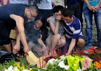 This photo taken on July 29, 2011 shows family members lighting and leaving sticks of incense as they mourn victims who died in the July 23 high-speed train crash at the accident scene in Shuangyu, near Wenzhou, in eastern China's Zhejiang province This photo taken on July 29, 2011 shows family members lighting and leaving sticks of incense as they mourn victims who died in the July 23 high-speed train crash at the accident scene in Shuangyu, near Wenzhou, in eastern China's Zhejiang province