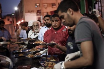 Libyan men get trays of food to break their fast at the end of the first fasting day of Islam's holy month of Ramadan in the rebel stronghold of Benghazi on August 1, 2011 Libyan men get trays of food to break their fast at the end of the first fasting day of Islam's holy month of Ramadan in the rebel stronghold of Benghazi on August 1, 2011