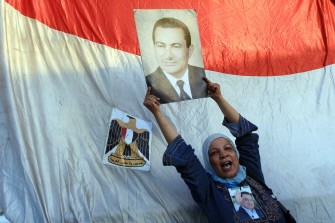 AFP - A supporter Hosni Mubarak holds his picture outside the police academy where Mubarak's trial is held on the outskirt of Cairo on August 3, 2011 AFP - A supporter Hosni Mubarak holds his picture outside the police academy where Mubarak's trial is held on the outskirt of Cairo on August 3, 2011