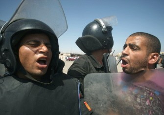 AFP - An Egyptian protestor argues with riot police outside the court set up in the Cairo Police Academy, on August 03, 2011, for the trial of Egypt's ousted president and his two sons AFP - An Egyptian protestor argues with riot police outside the court set up in the Cairo Police Academy, on August 03, 2011, for the trial of Egypt's ousted president and his two sons