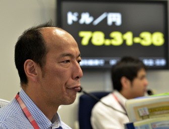 AFP - A currency trader reacts during the morning trading session at a Tokyo foreign exchange market on August 4, 2011 AFP - A currency trader reacts during the morning trading session at a Tokyo foreign exchange market on August 4, 2011