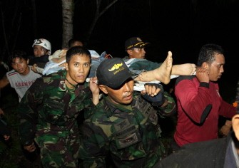 AFP - Rescue team evacuate Dian Rimba Rudiansyamar, a survivor of the helicopter crash AFP - Rescue team evacuate Dian Rimba Rudiansyamar, a survivor of the helicopter crash