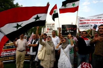 Members of a pro-Islamic human rights group chant slogans, wave flags and carry signs calling for the removal of Syrian president Bashar al Assad and his regime during a demonstration outside the Syrian Embassy in Ankara, on August 1, 2011. Members of a pro-Islamic human rights group chant slogans, wave flags and carry signs calling for the removal of Syrian president Bashar al Assad and his regime during a demonstration outside the Syrian Embassy in Ankara, on August 1, 2011.