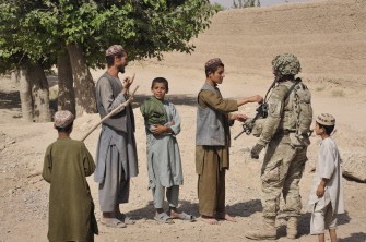 A US soldier from the 3rd Platoon, Charlie Company, 2-87 Infantry, 3d Brigade Combat Team greets Afghan villagers as troops seal a canal running thru Highway 1 in the outskirts of Kandalay village in Kandahar province on August 6, 2011 A US soldier from the 3rd Platoon, Charlie Company, 2-87 Infantry, 3d Brigade Combat Team greets Afghan villagers as troops seal a canal running thru Highway 1 in the outskirts of Kandalay village in Kandahar province on August 6, 2011
