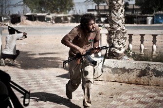AFP - Libyan rebels come under fire at an intersection beyond Bir Ghanam during fighting with forces loyal to Libya's leader Moamer Kadhafi, 80 kilometres southwest of the Libyan capital Tripoli on August 6, 2011 AFP - Libyan rebels come under fire at an intersection beyond Bir Ghanam during fighting with forces loyal to Libya's leader Moamer Kadhafi, 80 kilometres southwest of the Libyan capital Tripoli on August 6, 2011