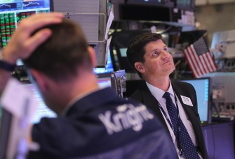 AFP - Traders look on at the New York Stock Exchange moments after the Federal Reserve made its policy announcement on August 9, 2011 in New York City AFP - Traders look on at the New York Stock Exchange moments after the Federal Reserve made its policy announcement on August 9, 2011 in New York City