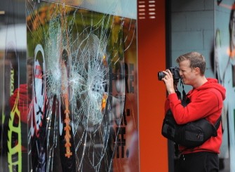 AFP - A member of the public takes pictures of the damage to the shop front of a retail store in Manchester City Centre on August 10, 2011, following a fourth night of violence in Britain. AFP - A member of the public takes pictures of the damage to the shop front of a retail store in Manchester City Centre on August 10, 2011, following a fourth night of violence in Britain.