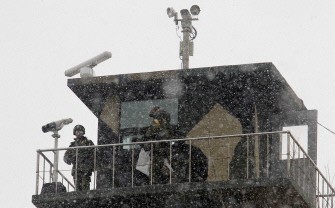 In a file picture taken on December 27, 2010 South Korean marines stand guard at a guard post on Yeonpyeong island near the disputed Yellow Sea border. In a file picture taken on December 27, 2010 South Korean marines stand guard at a guard post on Yeonpyeong island near the disputed Yellow Sea border.