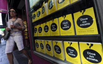AFP - A woman leaves a bookshop displaying on its window Christopher Hitchens's book "God is not great", in Madrid, on August 17, 2011, on the eve of Pope Benedict XVI's arrival AFP - A woman leaves a bookshop displaying on its window Christopher Hitchens's book "God is not great", in Madrid, on August 17, 2011, on the eve of Pope Benedict XVI's arrival