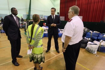 AFP - British Prime Minister David Cameron (C) visits the Community Assistance Centre in Tottenham Green Leisure Centre with local MP David Lammy (L) on August 16, 2011 in London. Cameron visited the assistance centre which is providing donated food and clothes as well as council services to residents and businesses affected by the recent riots. AFP - British Prime Minister David Cameron (C) visits the Community Assistance Centre in Tottenham Green Leisure Centre with local MP David Lammy (L) on August 16, 2011 in London. Cameron visited the assistance centre which is providing donated food and clothes as well as council services to residents and businesses affected by the recent riots.