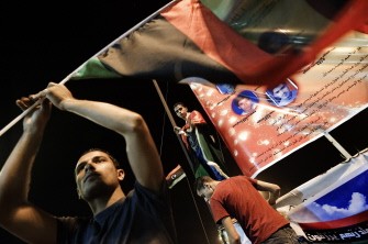 AFP- Libyans listen to the arrest of Kadhafi's son Saif al-islam and the partial fall of Tripoli on August 21, 2011 in Benghazi, Libya AFP- Libyans listen to the arrest of Kadhafi's son Saif al-islam and the partial fall of Tripoli on August 21, 2011 in Benghazi, Libya