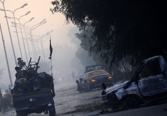 Rebel fighters patrol the streets in a neighborhood south of the capital Tripoli on August 25, 2011. Rebel fighters patrol the streets in a neighborhood south of the capital Tripoli on August 25, 2011.