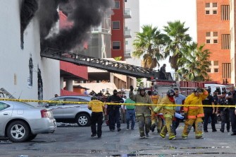 Red Cross personnel take a body outside the Casino Royale in Monterrey, Mexico on August 25, 2011 Red Cross personnel take a body outside the Casino Royale in Monterrey, Mexico on August 25, 2011