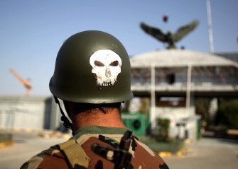 A Libyan rebel with a skull on his helmet stands guard outside the Salaheddin army barracks of the elite 32 Brigade near Tripoli on August 27, 2011. A Libyan rebel with a skull on his helmet stands guard outside the Salaheddin army barracks of the elite 32 Brigade near Tripoli on August 27, 2011.
