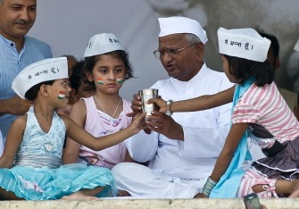 Anti-corruption activist Anna Hazare breaks his fast with Indian children on the 13th day of his hunger strike at the Ram Lila grounds in New Delhi on August 28, 2011. Anti-corruption activist Anna Hazare breaks his fast with Indian children on the 13th day of his hunger strike at the Ram Lila grounds in New Delhi on August 28, 2011.