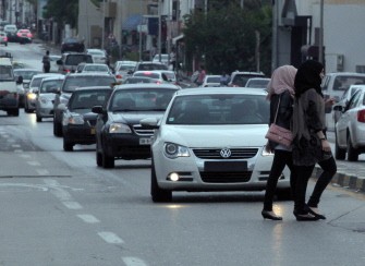 Two Libyan women cross the road as traffic drives along a main thoroughfare in Tripoli, on October 8, 2011 Two Libyan women cross the road as traffic drives along a main thoroughfare in Tripoli, on October 8, 2011