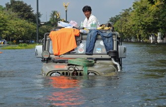 AFP - A Thai resident sits on his vehicle surrounded by floodwaters in the ancient Thai capital of Ayutthaya, 80 kms north of Bangkok, on October 12, 2011. AFP - A Thai resident sits on his vehicle surrounded by floodwaters in the ancient Thai capital of Ayutthaya, 80 kms north of Bangkok, on October 12, 2011.