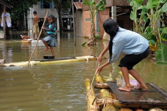Cambodian children stand on their banana-trunk rafts to negotiate floodwaters in Kandal province, 20kms east of Phnom Penh, on October 13, 2011. Cambodian children stand on their banana-trunk rafts to negotiate floodwaters in Kandal province, 20kms east of Phnom Penh, on October 13, 2011.