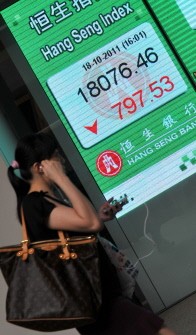 A woman walks past a display board showing the Hang Seng stock market index in Hong Kong on October 18, 2011 A woman walks past a display board showing the Hang Seng stock market index in Hong Kong on October 18, 2011