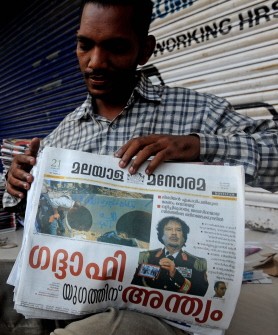 An Indian newspaper vendor counts papers carrying the news of the death of former Libyan leader Moamer Kadhafi on its front page at a distribution centre in Mumbai on October 21, 2011 An Indian newspaper vendor counts papers carrying the news of the death of former Libyan leader Moamer Kadhafi on its front page at a distribution centre in Mumbai on October 21, 2011
