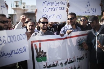 Workers at Libya's Waha Oil Company hold signs during a demonstration in Tripoli on October 19, 2011 to demand the resignation of their boss for alleged corruption and ties to the old regime, saying his refusal to quit was costing $36 million daily. Workers at Libya's Waha Oil Company hold signs during a demonstration in Tripoli on October 19, 2011 to demand the resignation of their boss for alleged corruption and ties to the old regime, saying his refusal to quit was costing $36 million daily.