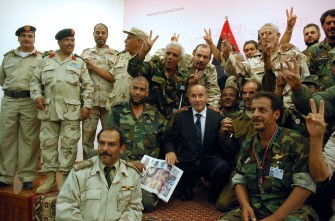 Libya's interim leader Mustafa Abdel Jalil (C) poses for a picture with National Transitional Council (NTC) fighters during a press conference in the eastern city of Benghazi on October 24, 2011. Libya's interim leader Mustafa Abdel Jalil (C) poses for a picture with National Transitional Council (NTC) fighters during a press conference in the eastern city of Benghazi on October 24, 2011.