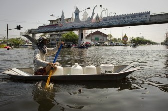 AFP - A local resident uses a boat to get water, in a street in the flood waters, in Rangsit, Pathum Thani Province, outskirts of Bangkok, on October 25, 2011. AFP - A local resident uses a boat to get water, in a street in the flood waters, in Rangsit, Pathum Thani Province, outskirts of Bangkok, on October 25, 2011.