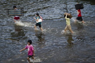 AFP - Local residents carry belongings through floodwaters in an area near the Chao Praya river in Bangkok on October 29, 2011. AFP - Local residents carry belongings through floodwaters in an area near the Chao Praya river in Bangkok on October 29, 2011.