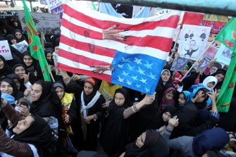 Iranian women hold up an upside down US flag outside the former US embassy in Tehran on November 4, 2011, during a rally to mark the storming of the American embassy by Iranian students 32 years ago. Iranian women hold up an upside down US flag outside the former US embassy in Tehran on November 4, 2011, during a rally to mark the storming of the American embassy by Iranian students 32 years ago.