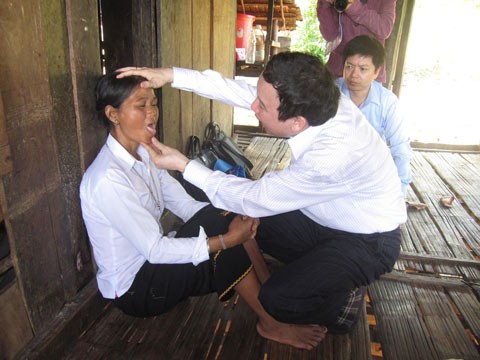 A medic examining a patient in Reu Village A medic examining a patient in Reu Village