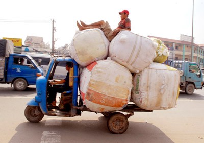 A dangerous overloaded tattered vehicle blatantly runs on streets A dangerous overloaded tattered vehicle blatantly runs on streets