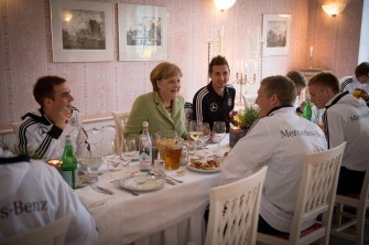 German Chancellor Angela Merkel (C) meets with Germany's national football team players Captain Philip Lahm, Miroslav Klose and Bastian Schweinsteiger during a dinner in Sopot on June 6, 2012, ahead of the EURO 2012 football championships. German Chancellor Angela Merkel (C) meets with Germany's national football team players Captain Philip Lahm, Miroslav Klose and Bastian Schweinsteiger during a dinner in Sopot on June 6, 2012, ahead of the EURO 2012 football championships.