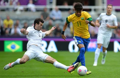Tiền đạo Neymar đi bóng qua hậu vệ Iann Hogg của New Zealand. Tiền đạo Neymar đi bóng qua hậu vệ Iann Hogg của New Zealand.