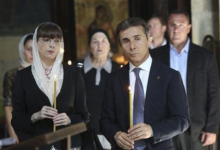 Leader of the opposition Georgian Dream coalition Bidzina Ivanishvili (R) and his wife Eka Khvedelidze attend a religious service in Tbilisi, October 1, 2012. Leader of the opposition Georgian Dream coalition Bidzina Ivanishvili (R) and his wife Eka Khvedelidze attend a religious service in Tbilisi, October 1, 2012.