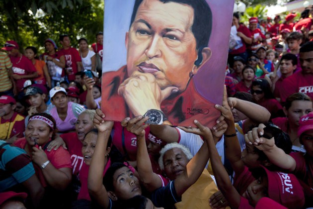 Supporters of Venezuela's President Hugo Chavez hold up an image of him during a campaign caravan from Barinas to Caracas, in Sabaneta, Venezuela, Monday, Oct. 1, 2012. Supporters of Venezuela's President Hugo Chavez hold up an image of him during a campaign caravan from Barinas to Caracas, in Sabaneta, Venezuela, Monday, Oct. 1, 2012.