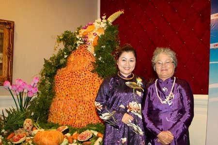 The mother-daughter duo standing next to their cuisine artwork The mother-daughter duo standing next to their cuisine artwork
