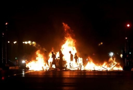 Lebanese men block a road leading to the airport in Beirut to protest against the assassination of top intelligence official Wissam al-Hassan in a car bombing... Lebanese men block a road leading to the airport in Beirut to protest against the assassination of top intelligence official Wissam al-Hassan in a car bombing...