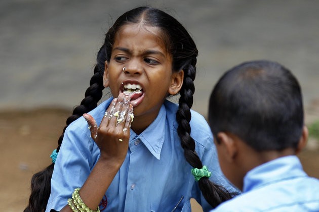 An Indian schoolgirl eats a free mid-day meal at a government run school on World Food Day in Bangalore, India, Tuesday, Oct. 16, 2012. An Indian schoolgirl eats a free mid-day meal at a government run school on World Food Day in Bangalore, India, Tuesday, Oct. 16, 2012.
