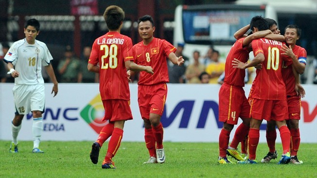 The file photo shows Vietnamese team members celebrating after a goal in a match over Philippines in September. The file photo shows Vietnamese team members celebrating after a goal in a match over Philippines in September.