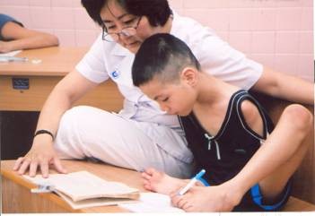The file photo shows a doctor of Tu Du Hospital teaching Tran Binh Minh, who was contaminated with dioxin in Agent Orange, in Hoa Binh Village inside the hospital. The file photo shows a doctor of Tu Du Hospital teaching Tran Binh Minh, who was contaminated with dioxin in Agent Orange, in Hoa Binh Village inside the hospital.