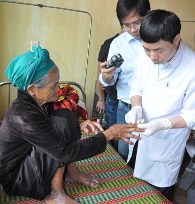 A doctor examines a patient suffering mystery skin disease