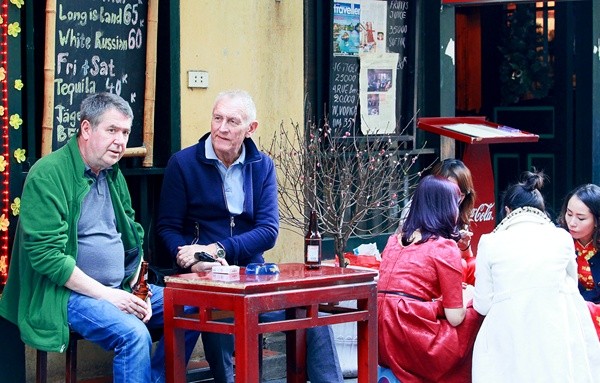 Two French men enjoy the Tet atmosphere in Ha Noi.