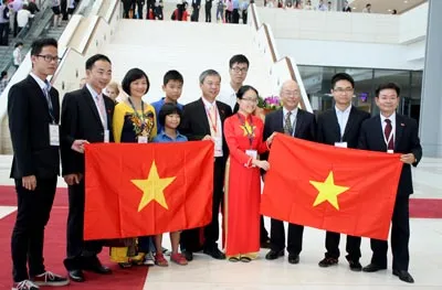Em Phạm Ngân Giang (áo dài màu đỏ) - đoạt huy chương vàng tại Olympic Hóa học quốc tế 2014 - trong niềm vui cùng với người thân. ẢNH: LÃ ANH Em Phạm Ngân Giang (áo dài màu đỏ) - đoạt huy chương vàng tại Olympic Hóa học quốc tế 2014 - trong niềm vui cùng với người thân. ẢNH: LÃ ANH