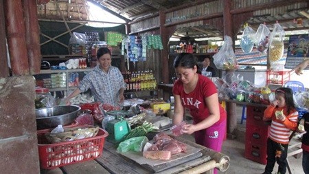 Nguyen Thi Hien (middle) prepares food at her corner shop. Her village shop is the result of a loan from the Micro Finance Unit in 2012. — Photo Courtesy of World Vision Nguyen Thi Hien (middle) prepares food at her corner shop. Her village shop is the result of a loan from the Micro Finance Unit in 2012. — Photo Courtesy of World Vision