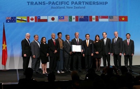 New Zealand Prime Minister John Key (C) and Ministerial Representatives from 12 countries pose for a photo after signing the Trans-Pacific Partnership agreement in Auckland. Minister of Industry and Trade, Vu Huy Hoang (first, right) represents Viet Nam to the signing ceremony. — AFP/VNA Photo New Zealand Prime Minister John Key (C) and Ministerial Representatives from 12 countries pose for a photo after signing the Trans-Pacific Partnership agreement in Auckland. Minister of Industry and Trade, Vu Huy Hoang (first, right) represents Viet Nam to the signing ceremony. — AFP/VNA Photo