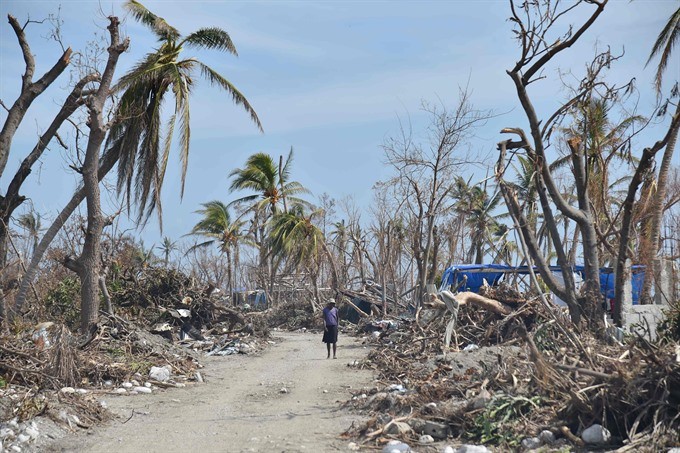 A woman walks in the street of Les Cayes, Haiti on Monday, following the passage of Hurricane Matthew. Haiti faces a humanitarian crisis that requires a massive response from the international community, the United Nations chief said , with at least 1.4 million people needing emergency aid following last week’s battering by Hurricane Matthew. A woman walks in the street of Les Cayes, Haiti on Monday, following the passage of Hurricane Matthew. Haiti faces a humanitarian crisis that requires a massive response from the international community, the United Nations chief said , with at least 1.4 million people needing emergency aid following last week’s battering by Hurricane Matthew.